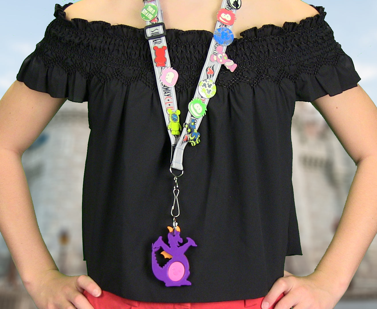 Girl using Figment Magic Band Buddy on a pin trading lanyard